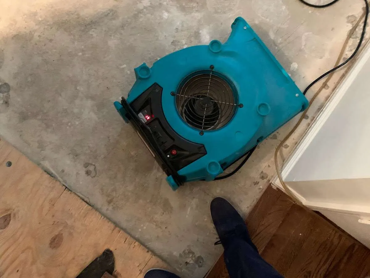 Air mover drying subfloor during Commercial Water Damage Restoration in Fox Lake